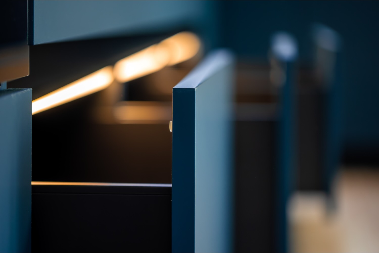 Warmes Licht aus einer verdeckten Nische zwischen dunklen Einbauteilen